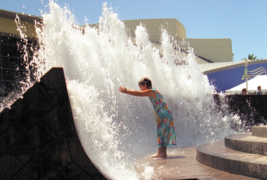 Child playing in the Aquarium Of The Pacific water fountain