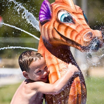 Child playing with Ocean Themed water park equipment